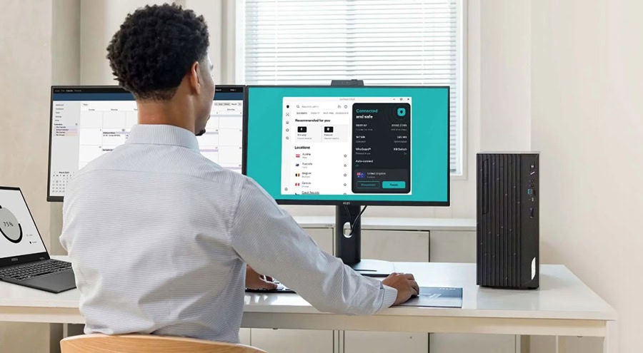 Yazılım geliştirme ortamında çalışan bir erkek bilgisayar başında kodlama yapıyor. İki monitör kullanıyor, biri kodlama diğeri ise uygulama arayüzü gösteriyor. Modern ofis ortamında, teknolojik ekipma.